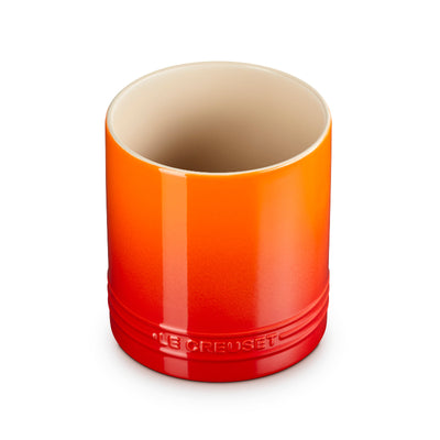 Orange ceramic cup with beige interior on a white background