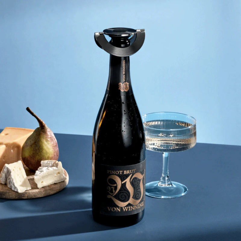 Bottle of VON WINNING wine with a wine opener on a blue background