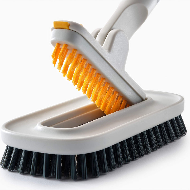 Cleaning brush with orange and black bristles on a white background