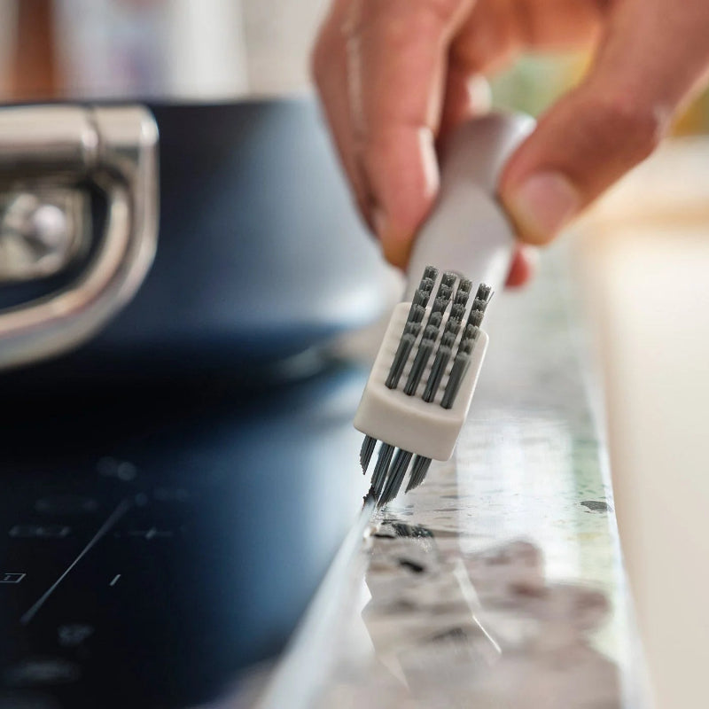 Person using a kitchen tool on a stove