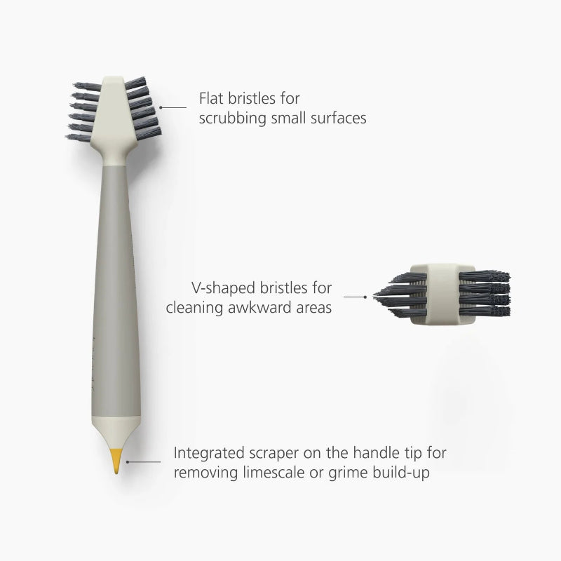 Cleaning brush with flat and V-shaped bristles on a white background