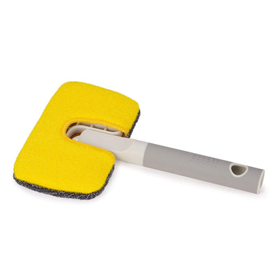 Yellow sponge with a metal handle on a white background
