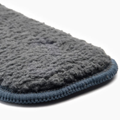 Gray textured cloth with blue border on a white background