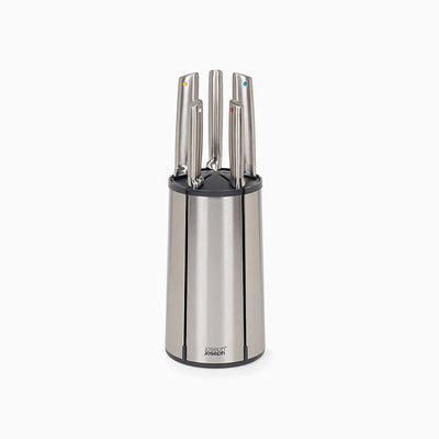 Stainless steel knife block with knives on a white background