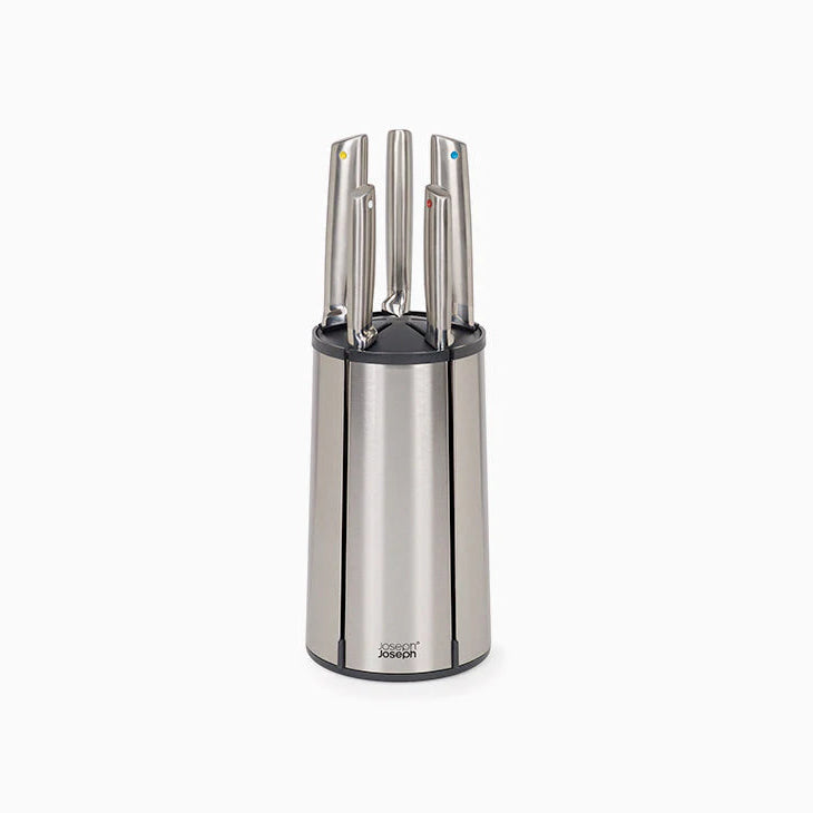 Stainless steel knife block with knives on a white background