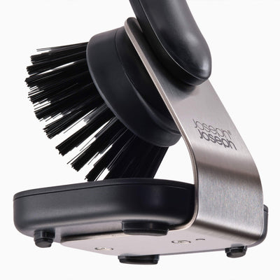 Dish brush with black bristles and silver handle on a white background, featuring the Joseph Joseph brand.