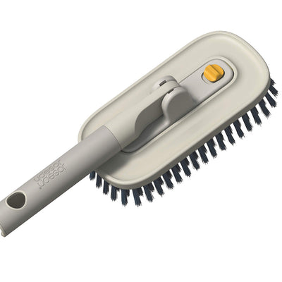 Cleaning brush with bristle head and gray handle on a white background