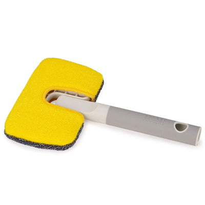 Yellow sponge with a gray handle on a white background