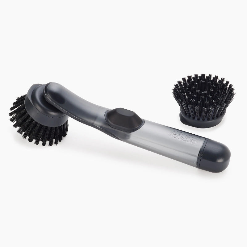 Two washing up brushes with black bristles on a white background