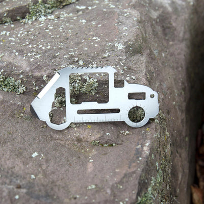Multitool shaped like a truck on a stone surface
