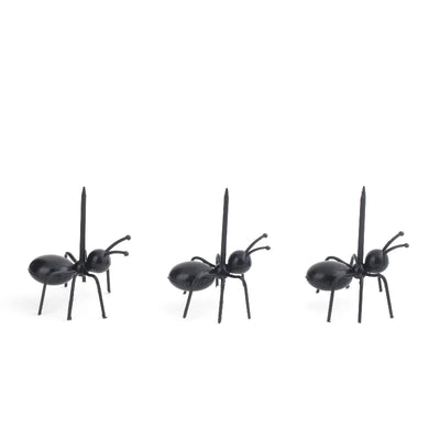 Three black ant figurines on a white background