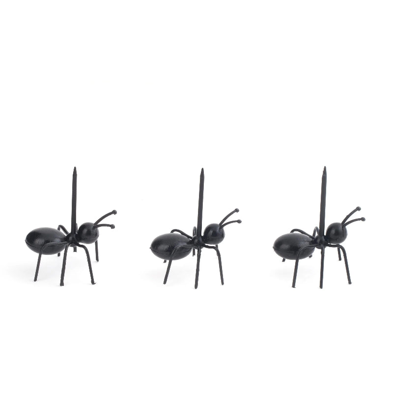 Three black ant figurines on a white background