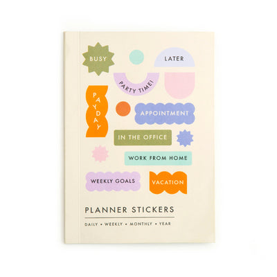 Planner stickers book with colorful labels on a beige background