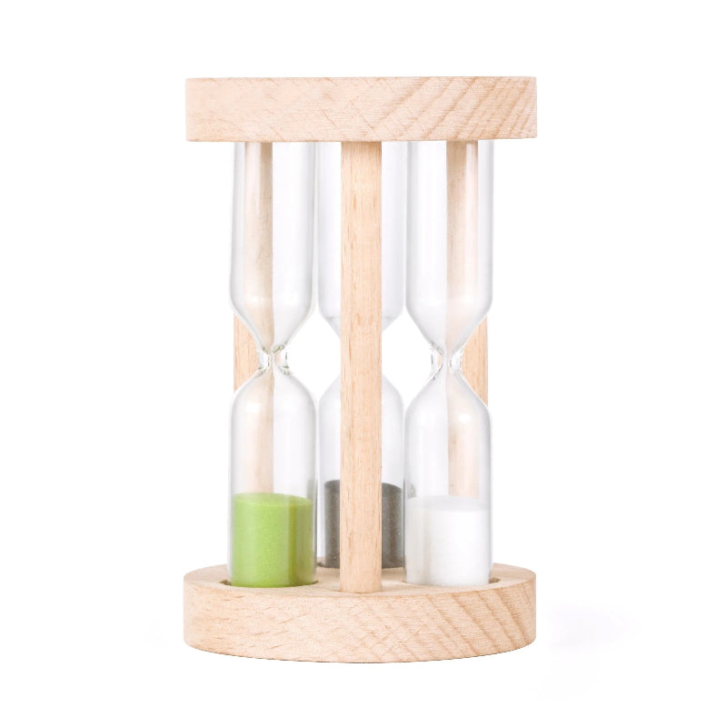 Wooden hourglass with a green candle inside on a white background