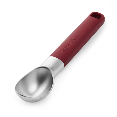 Red-handled ice cream scoop on a white background