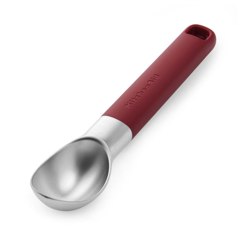 Red-handled ice cream scoop on a white background