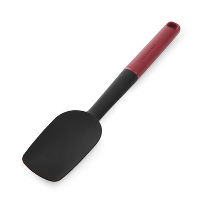 Black spatula with a red handle on a white background