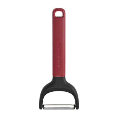 Red and black peeler with 'KitchenAid' branding on a white background