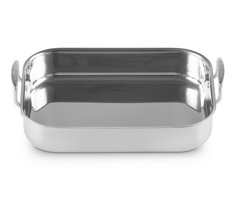 Stainless steel roasting pan on a white background
