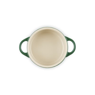 Green and beige ceramic baking dish on a white background
