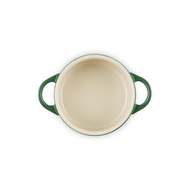 Green and beige ceramic baking dish on a white background