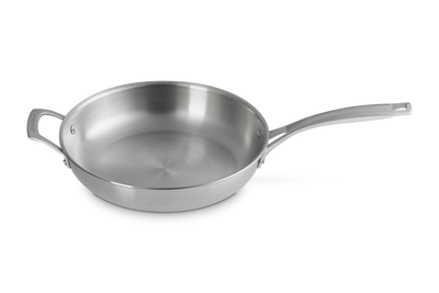 Stainless steel frying pan on a white background