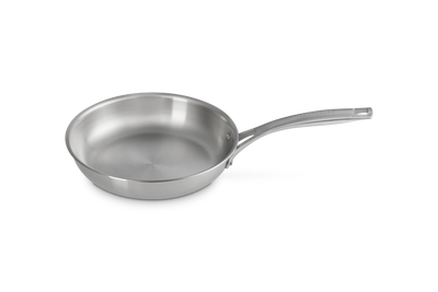 Stainless steel frying pan on a white background