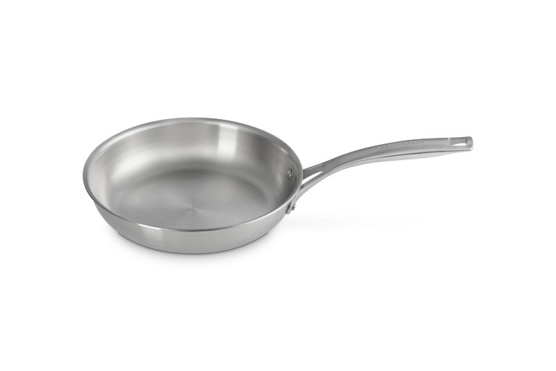 Stainless steel frying pan on a white background