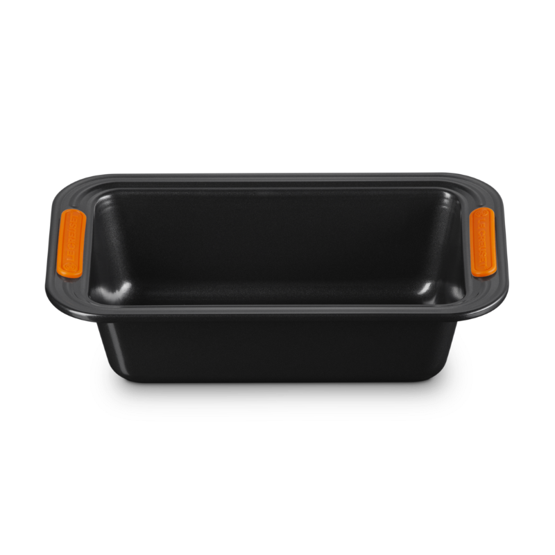 Black loaf pan with orange handles on a white background