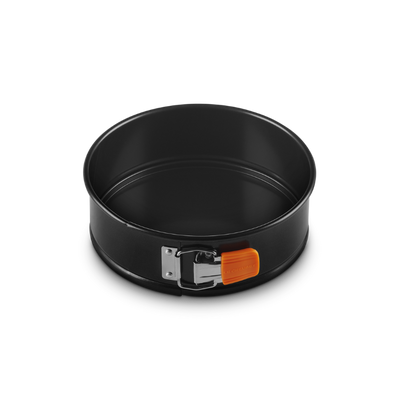 Black springform pan with a handle on a white background