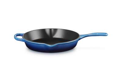 Blue cast iron skillet on a white background