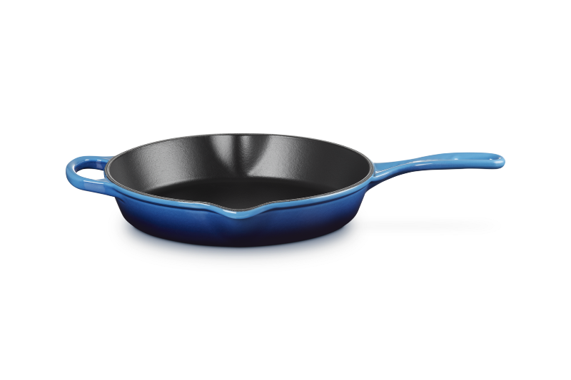 Blue cast iron skillet on a white background