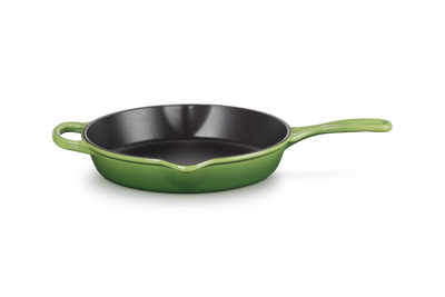 Green frying pan on a white background