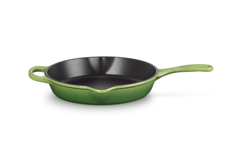 Green frying pan on a white background