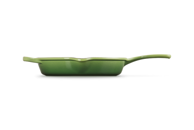 Green frying pan on a white background