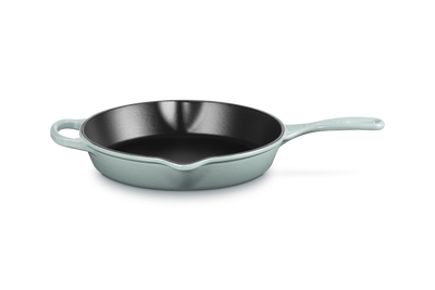 Skillet with light blue handle and body on a white background
