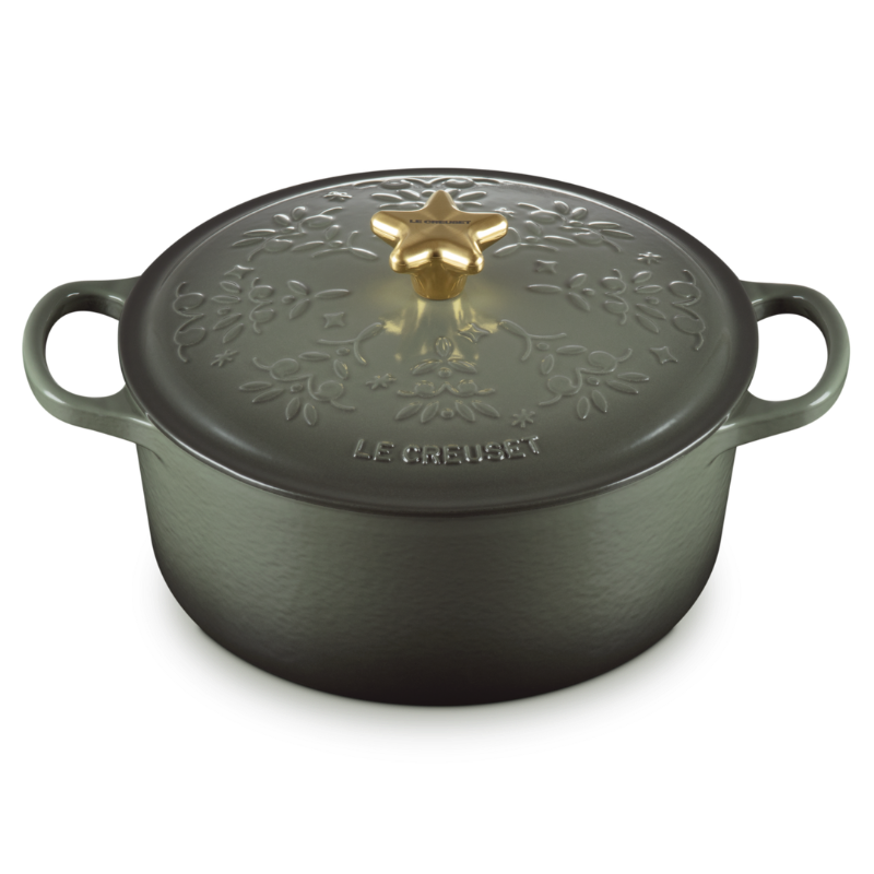 Black cast iron cookware pot with decorative lid on a white background