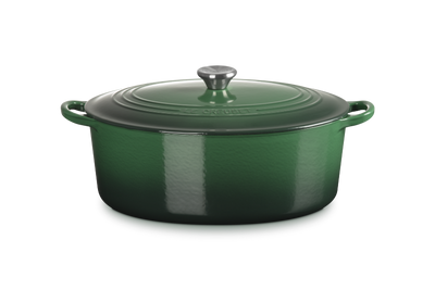 Green enameled cast iron Dutch oven with lid on a white background