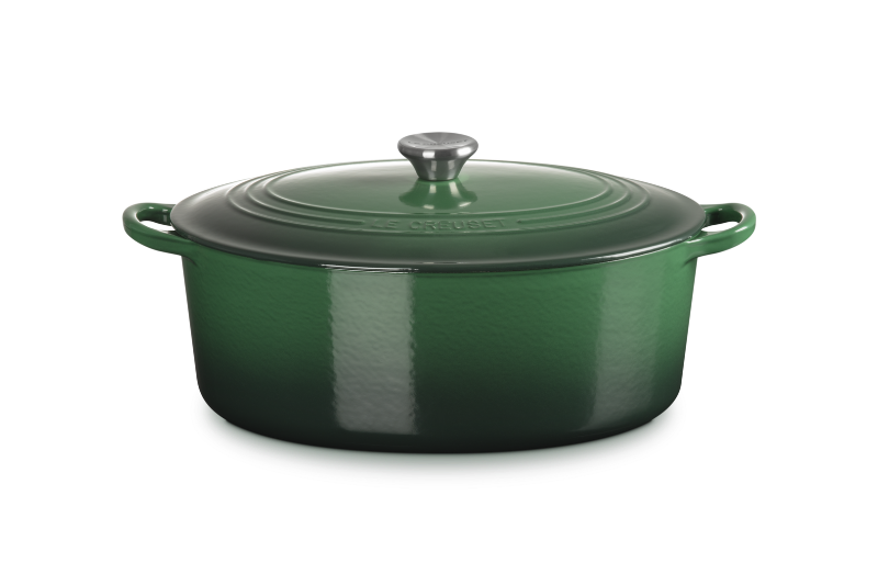 Green enameled cast iron Dutch oven with lid on a white background
