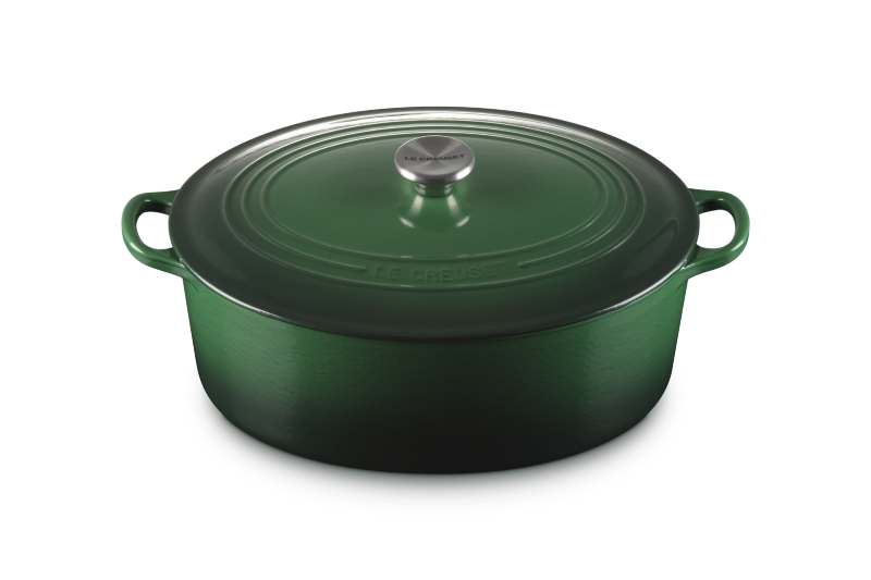 Green enameled cast iron Dutch oven with lid on a white background