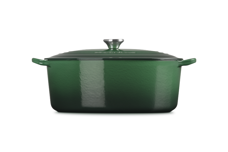 Green enameled cast iron casserole dish on a white background