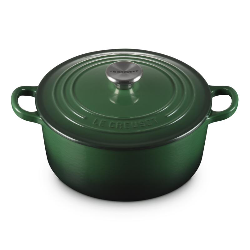 Green cast iron cookware pot on a white background