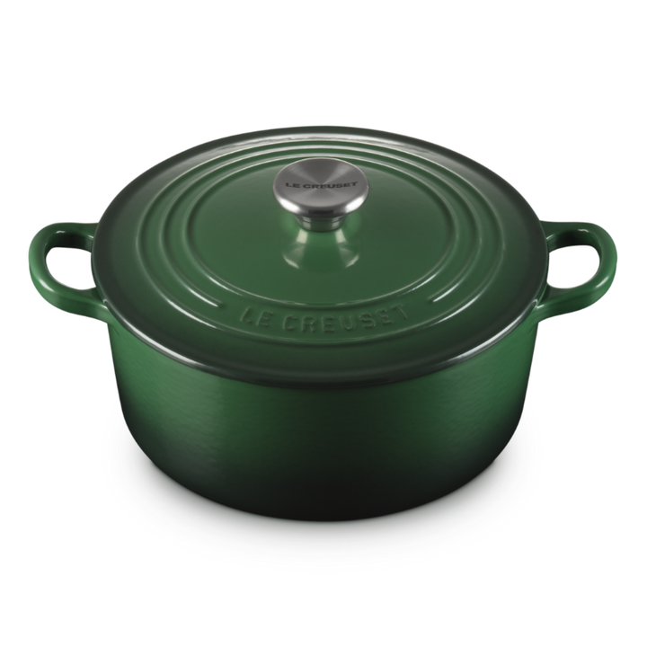 Green cast iron cookware pot on a white background