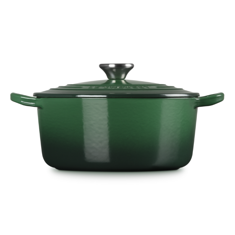 Green enameled cast iron Dutch oven on a white background