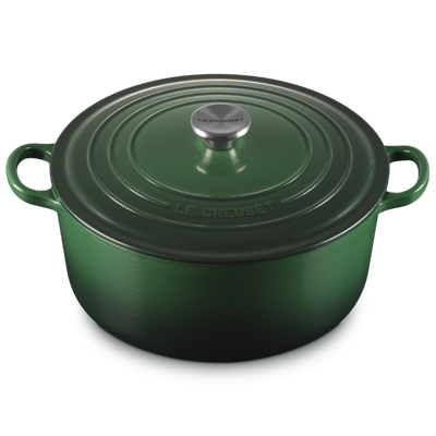 Green cast iron cookware pot with lid on a white background