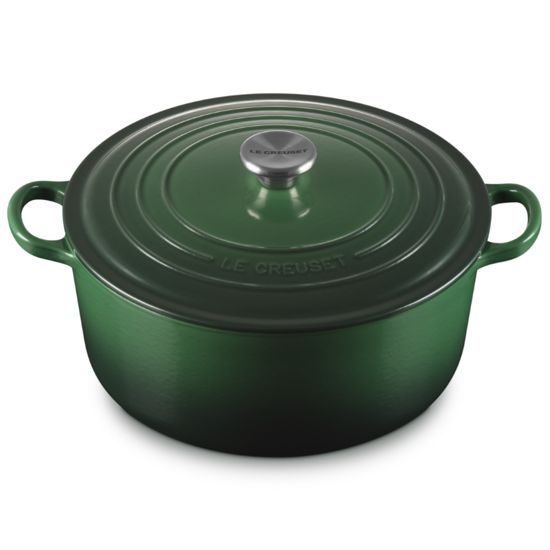 Green cast iron cookware pot with lid on a white background