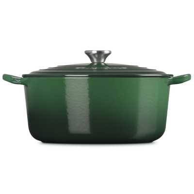 Green enameled cast iron Dutch oven on a white background