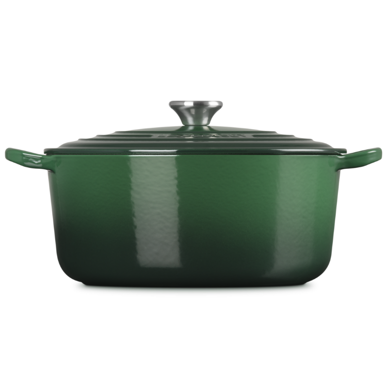 Green enameled cast iron Dutch oven on a white background