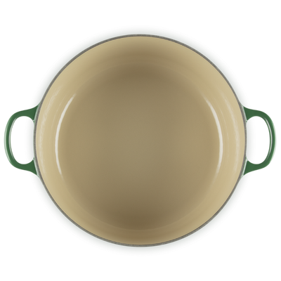 Green enameled cast iron skillet on a white background