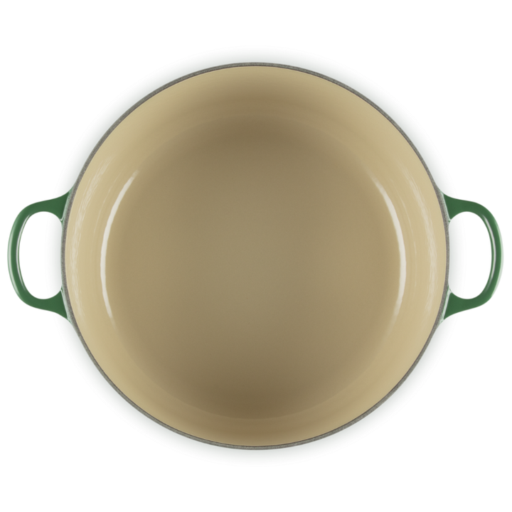 Green enameled cast iron skillet on a white background